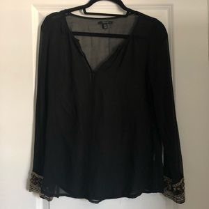 Black top with gold cuffs